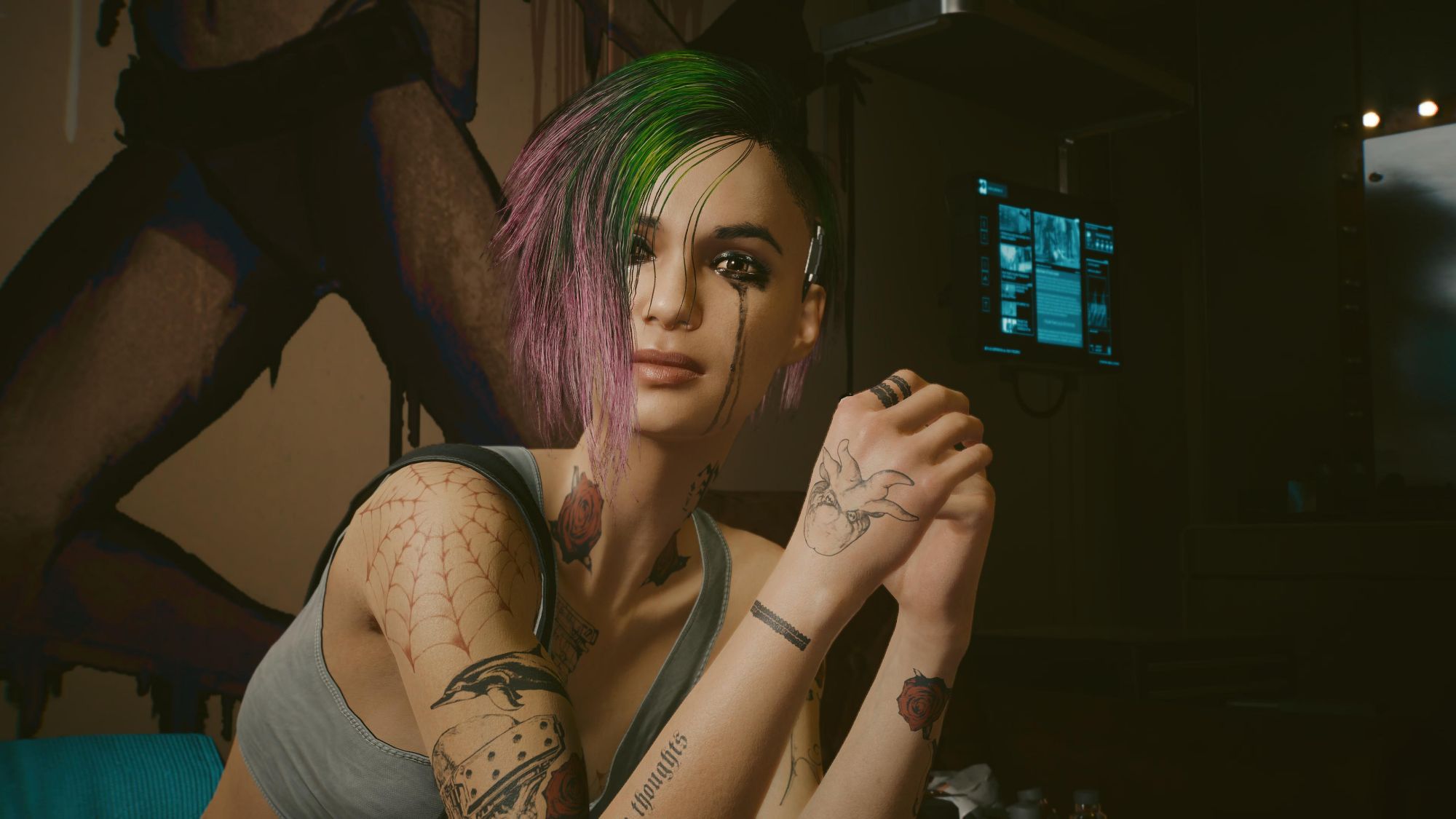 A young woman with green and light purple medium length hair combed to one side. She has tattoos on her arm. Her eye makeup is running down face as she has been crying.