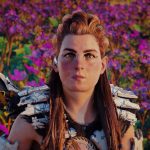 Woman with red hair, stood in front of a field of purple flowers. She wears white metal plate armour across her shoulders and a bow on her back. She looks directly at camera.
